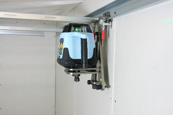 Floor and wall mount with fine drive for rotating laser